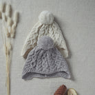 Kids Aran Woollen Mills ear flap caps in two colors