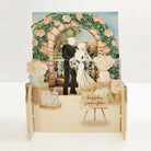 Pop-up wedding card with archway, flowers, and couple.